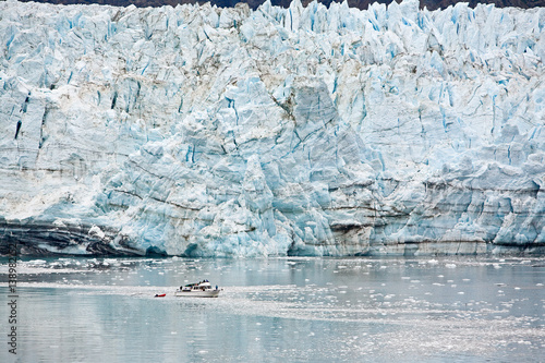 Marjorie Glacier in Glacier Bay, Alaska. Small boat in foreground shows size. photo