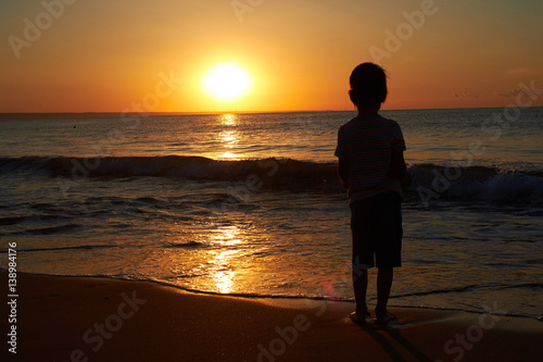 litle boy sunset at the sea