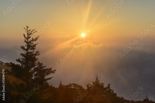 Dramatic Sunrise from Mountain Top with Foggy Valley
