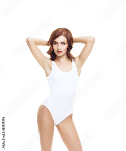 Fit and sporty girl in white underwear. Beautiful and healthy woman posing over isolated white background. Sport, fitness, diet, weight loss and healthcare concept. © Acronym