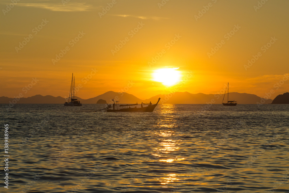 Sunset and traditional thai long boat around seaside, Ao Nang, Krabi province, Thailand