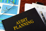 Book with title Audit planning on a table.