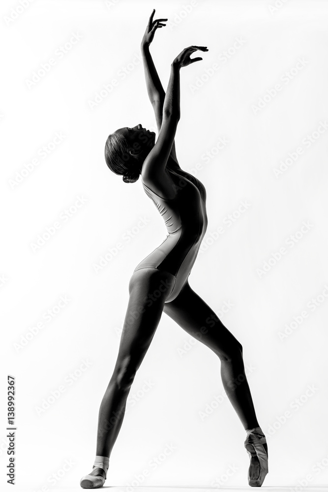 Young beautiful dancer posing in studio