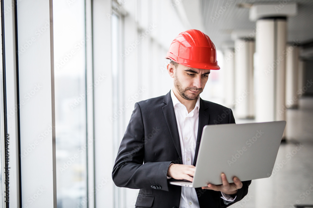 Handsome male engineer is using a notebook for work. Handsome male engineer is using a notebook for work.