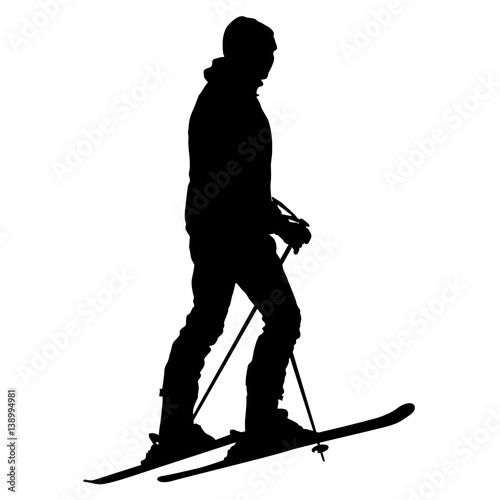 Skier standing on the snow. Vector sport silhouette