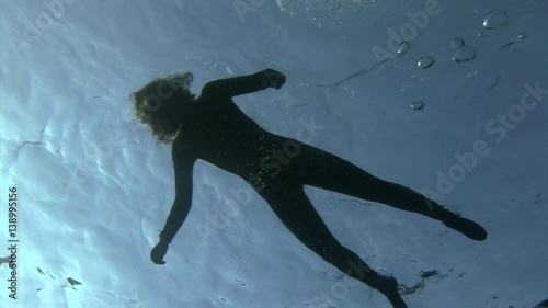 Silhouette of a girl in the water in Red Sea. Drowned. in Red Sea. Filming a movie.