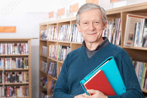 Mature Male Student Studying In Library