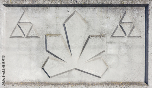 A fragment of concrete fence. Tracery pattern of stone wall as triangle.