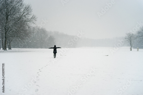 Woman in the snow in a park