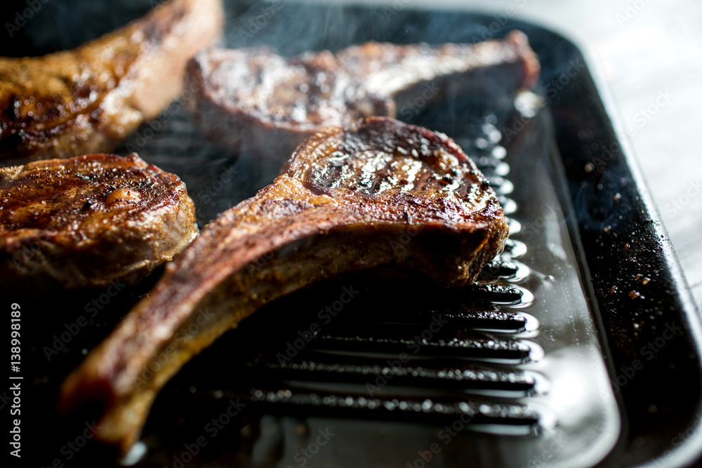 Spiced lamb rib chops with dates, feta, sumac, and tahini in pan Stock Photo Adobe Stock