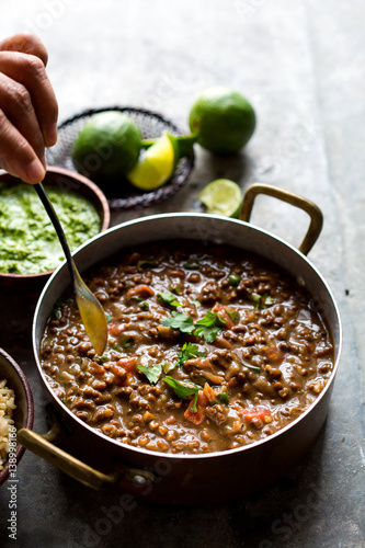 Hand stirring food in saucepan