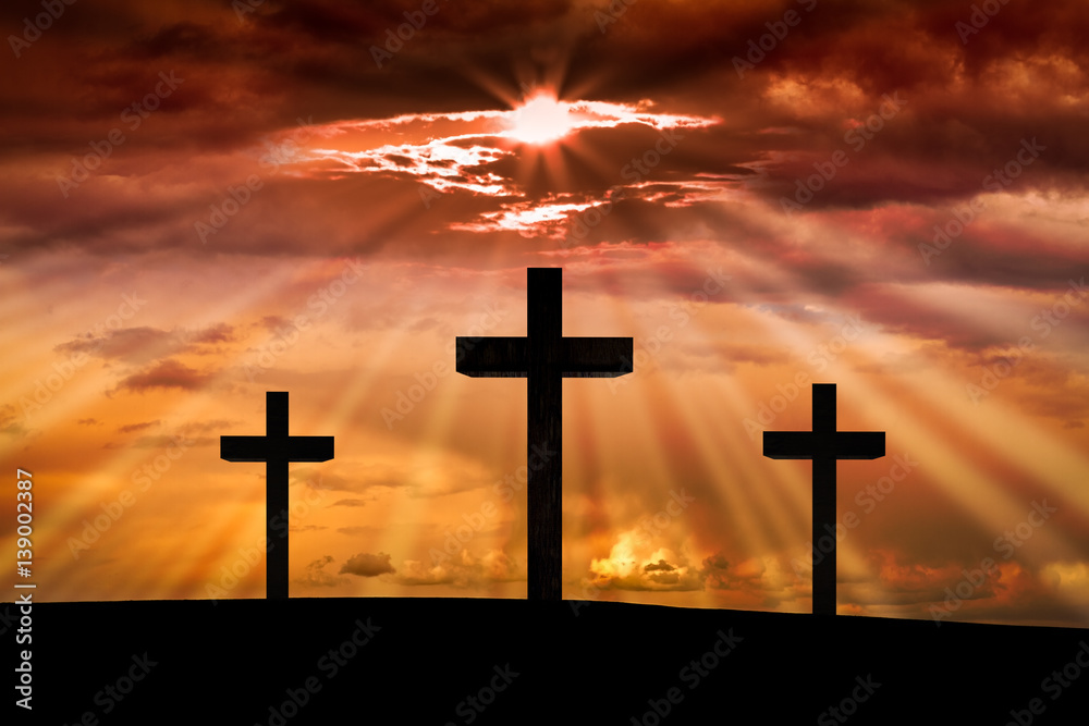 Jesus Christ cross on a background with dramatic sky,lighting,red, orange  sunset,clouds,sunbeams,sun rays glowing behind three crosses on Golgotha  , resurrection, Good Friday concept. Photos | Adobe Stock