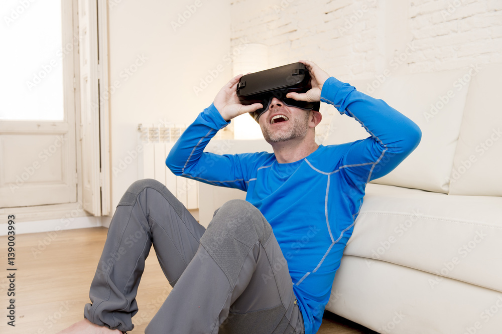 Obraz premium happy man at home living room sofa couch excited using 3d goggles watching 360 virtual reality