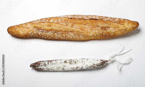 Bread and fuet on white background. Spanish sausage. Isolated.