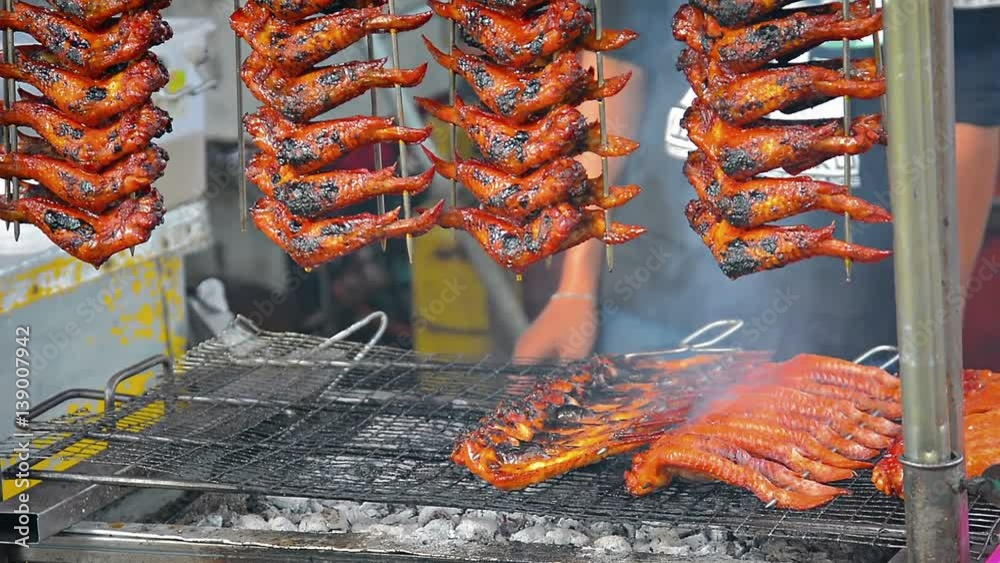 Chicken wings over hot coals on a street vendor's cart in Kota Kinabalu