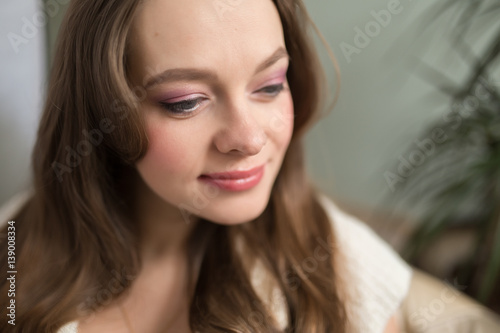 Closeup of young adult darling woman face with day makeup