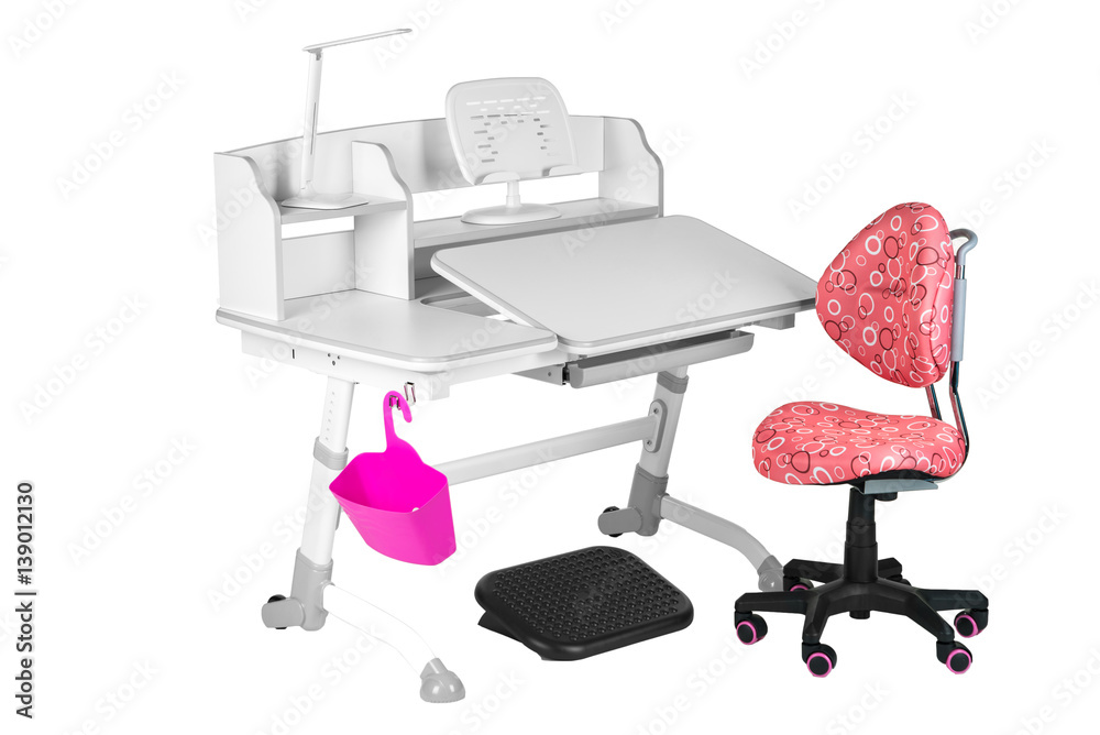 Pink chair, gray school desk, pink basket, desk lamp and black support under legs Pink chair, gray school desk, pink basket, desk lamp and black support under legs