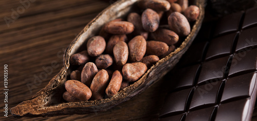 Cocoa pod and cocoa beans on the wooden table