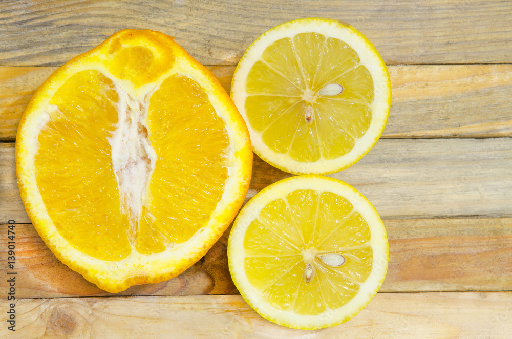 Cut orange and lemon on wooden background. Cut orange and lemon on wooden background.