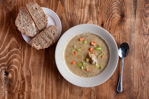 Grandma's soup with a spoon and bread photo