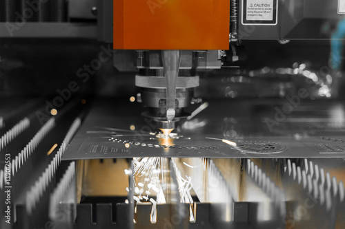 CNC laser cutting metal sheet with bright sparkle