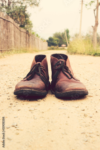 Vintage tone: Leather Shoe on dirt road