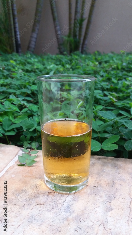 A glass cup with beer A glass cup with beer