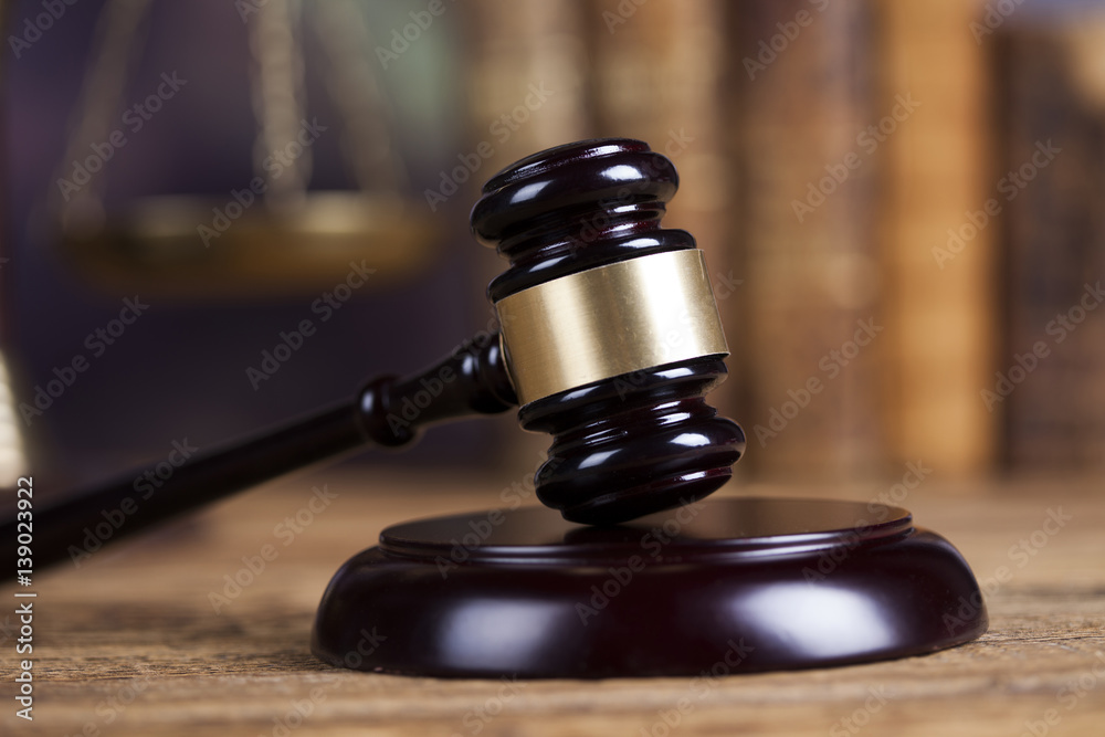 Law theme, mallet of the judge, wooden desk background Law theme, mallet of the judge, wooden desk background