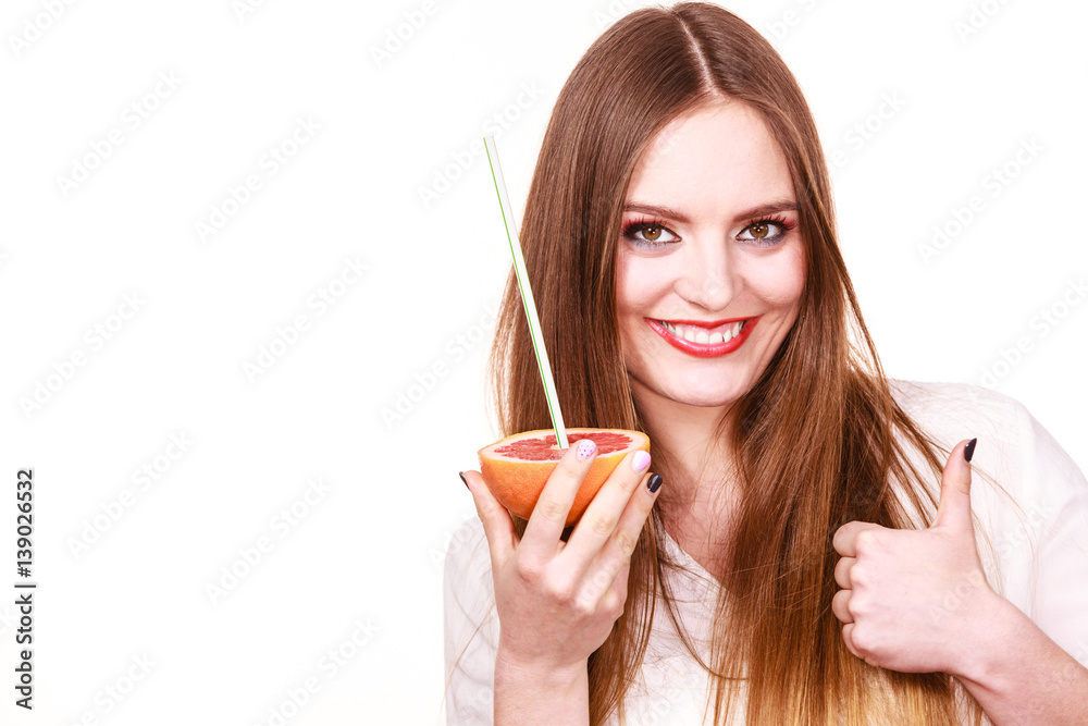 Woman holds grapefruit drinking juice from fruit Woman holds grapefruit drinking juice from fruit