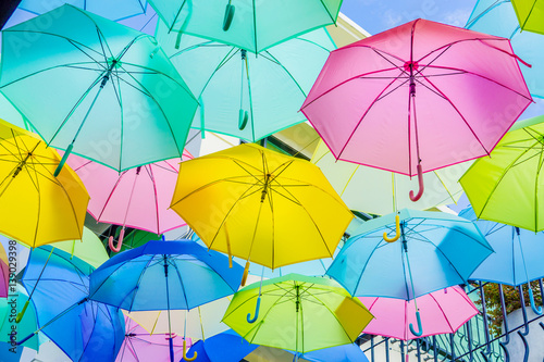 Hanging colorful umbrellas  on the street and blue sky.