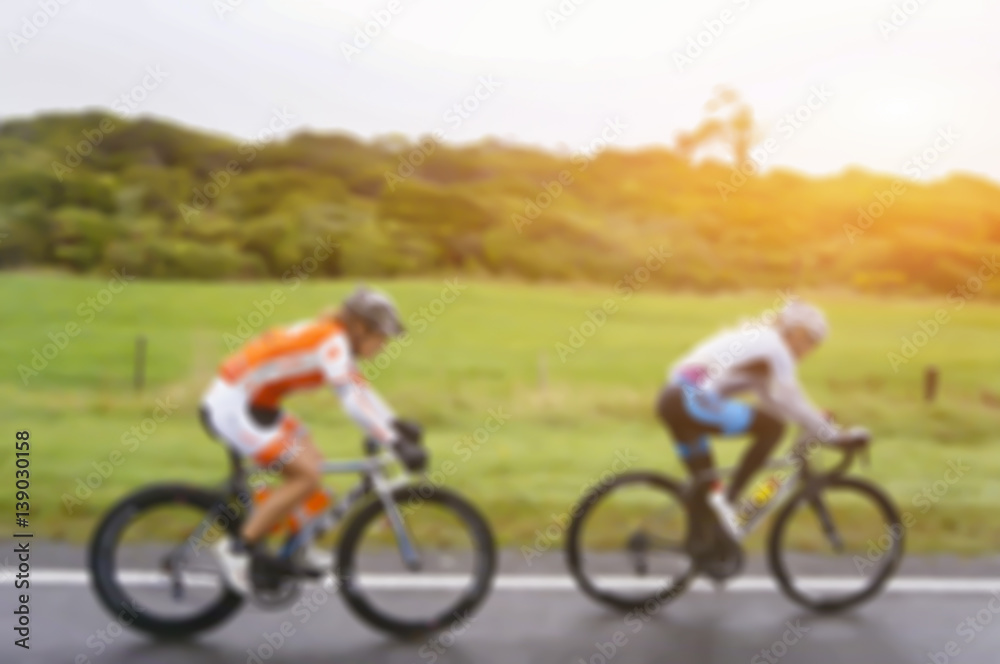  blurred background of hipster on bike in the city at sunset,men and women are cycling road bike in the morning,vintage color