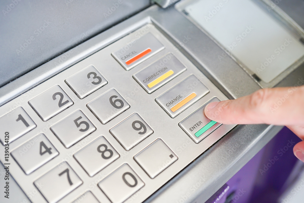 Asian BusinessMan hand is entering number on ATM machine to deposit / withdraw money, Financial Banking Technology Automatic machine Transfers background concept Asian BusinessMan hand is entering number on ATM machine to deposit / withdraw money, Financial Banking Technology Automatic machine Transfers background concept