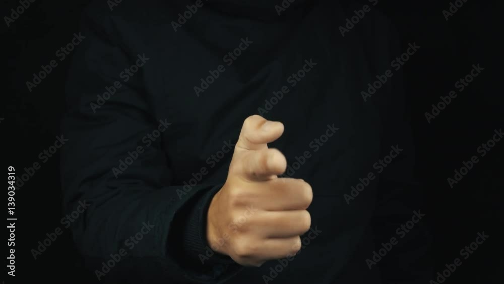 Caucasian male hand in long sleeve jacket finger mimicking pistol shooting gesture on black backround, close up isolated Caucasian male hand in long sleeve jacket finger mimicking pistol shooting gesture on black backround, close up isolated
