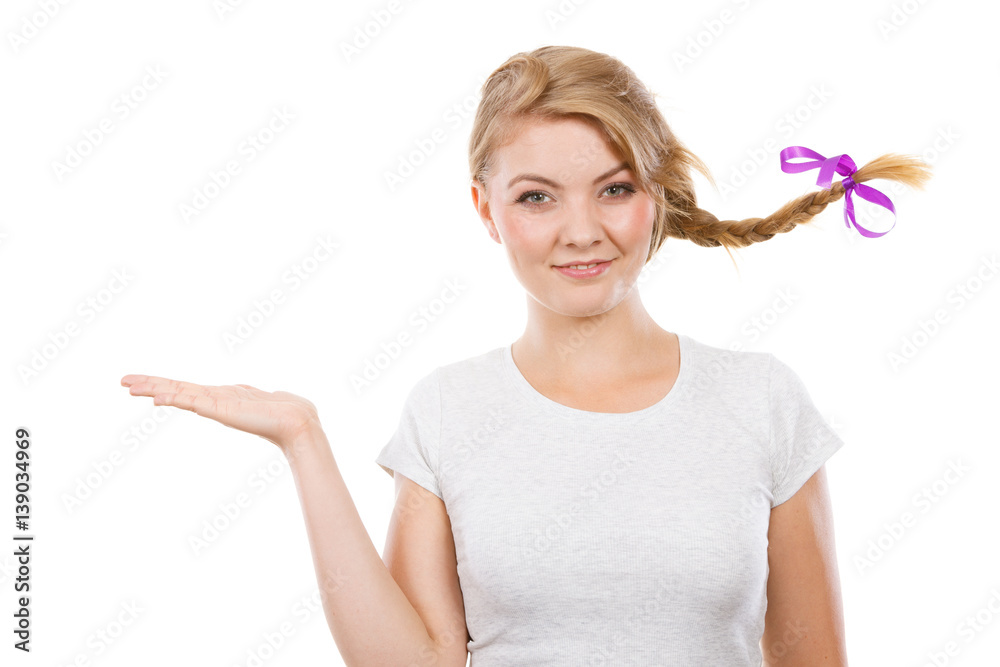 Happy teenage girl in braid hair presenting hand Happy teenage girl in braid hair presenting hand
