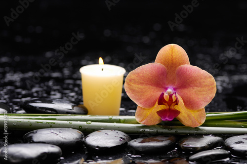 spa concept –orange orchid and long leaf ,candle