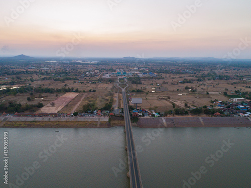 Aerial view of Bridge over Mae khong river at twilight sky. bridge in the night of Second Thai–Lao Friendship Bridge. connects Mukdahan Province in Thailand with Savannakhet in Laos.