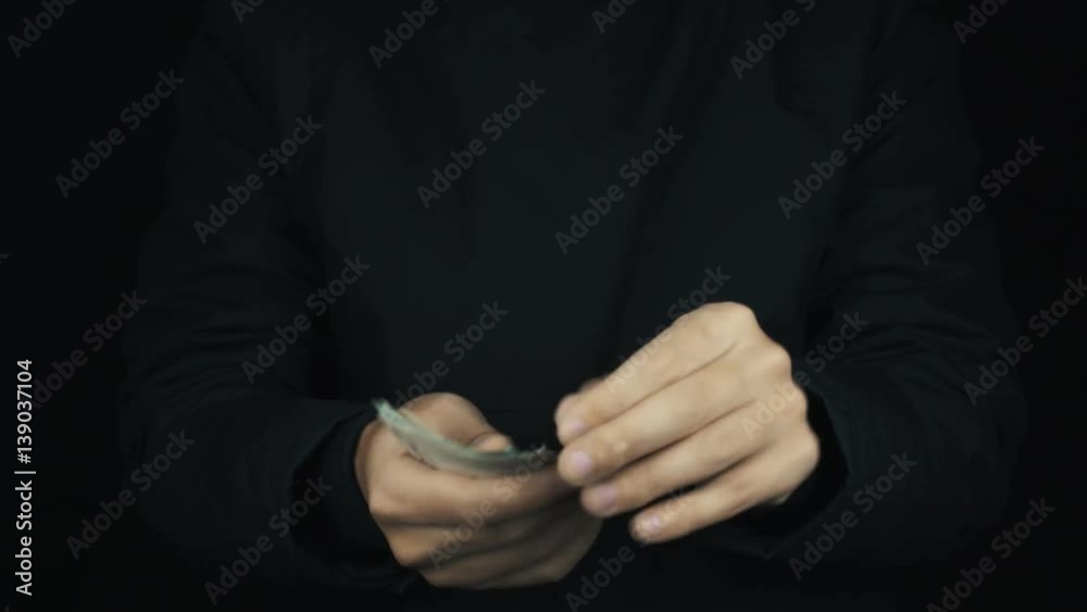 Caucasian male hand in long sleeve jacket pull hidden pile of ruble money bills up, counting it on black background, close up isolated Caucasian male hand in long sleeve jacket pull hidden pile of ruble money bills up, counting it on black background, close up isolated