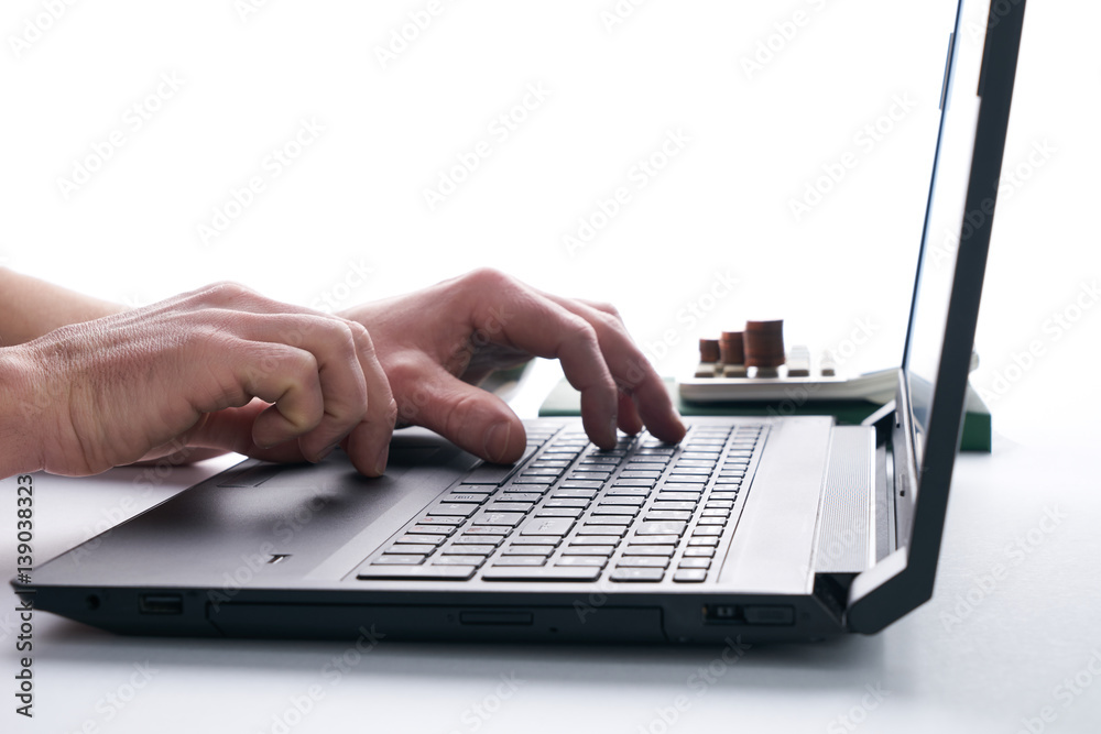Young businessman or accountant using his laptop, close up Young businessman or accountant using his laptop, close up
