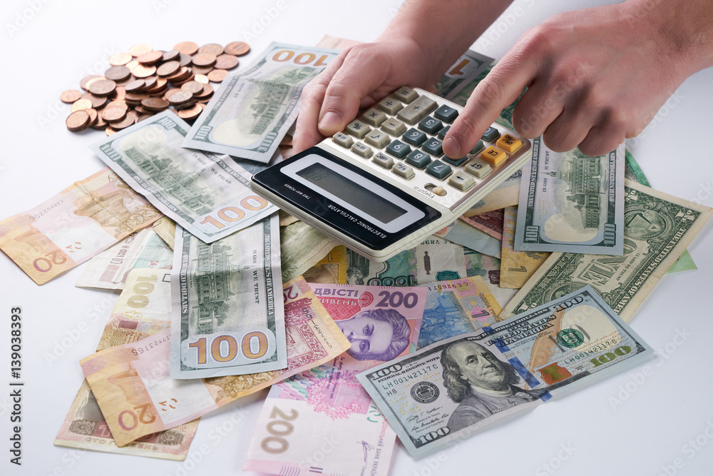 Accounting finance concept. Businessman or accountant using calculator with accounting report and financial statement and money. Accounting finance concept. Businessman or accountant using calculator with accounting report and financial statement and money.