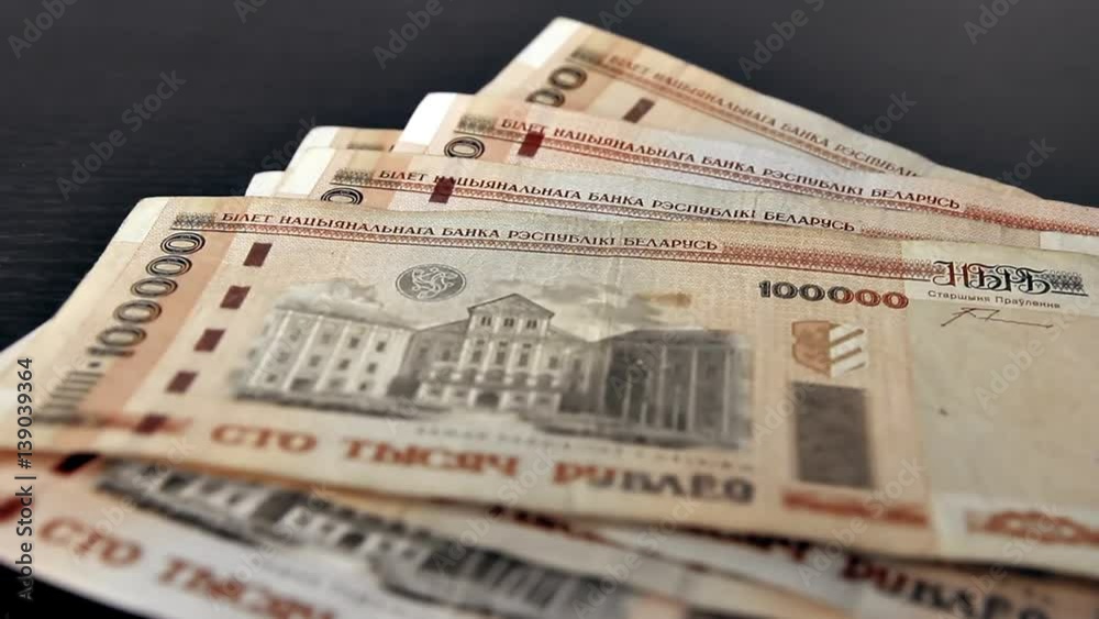 Counting old belarusian rubles (BYR). Man counts banknotes, 100000 rubles each, with total amount of two million rubles. Counting old belarusian rubles (BYR). Man counts banknotes, 100000 rubles each, with total amount of two million rubles.