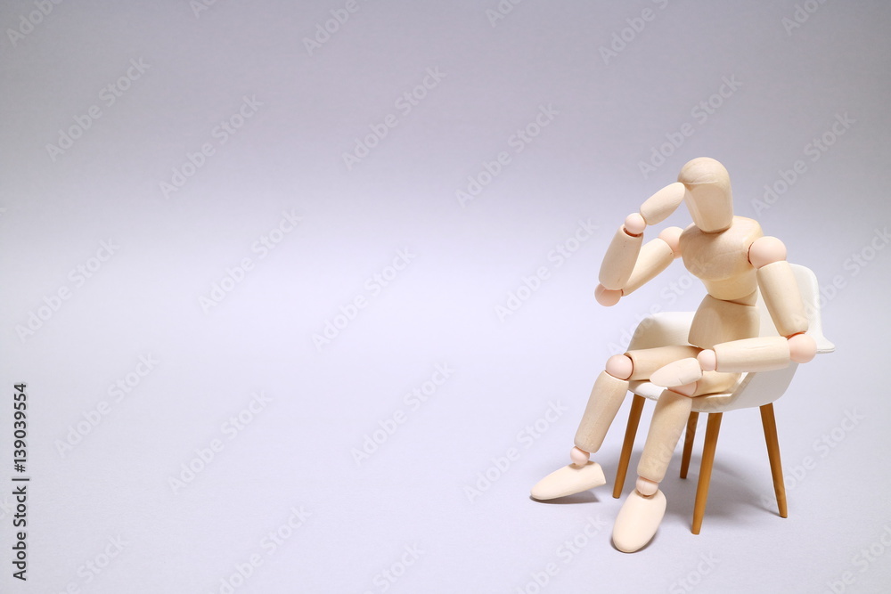 Wood mannequin on gray background Sit down and thinking Character space