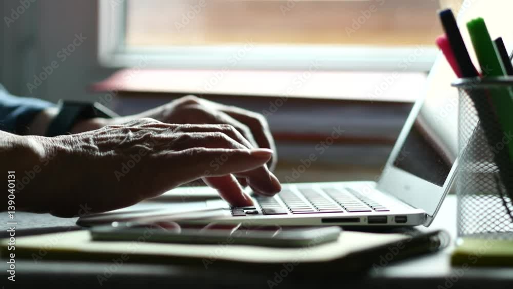 Elderly Business Man Typing On A Laptop