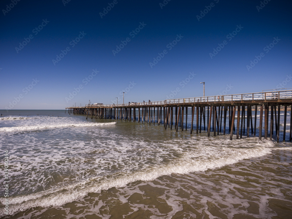 Aerial View of Pismo Beach Pier and Ocean with Surfers