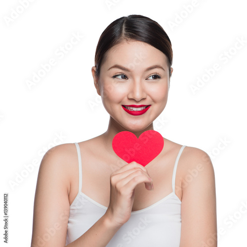 Attractive young woman with red heart. Valentine's day art portrait. Perfect make up