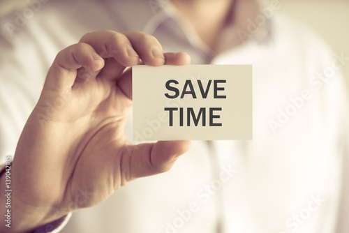 Businessman holding SAVE TIME message card