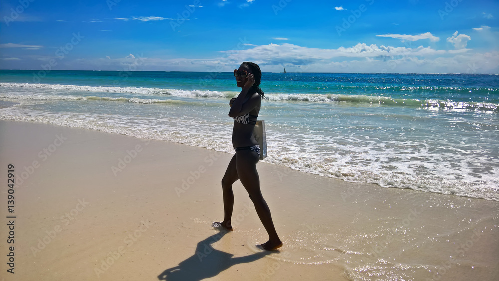 African girl walking on the beach