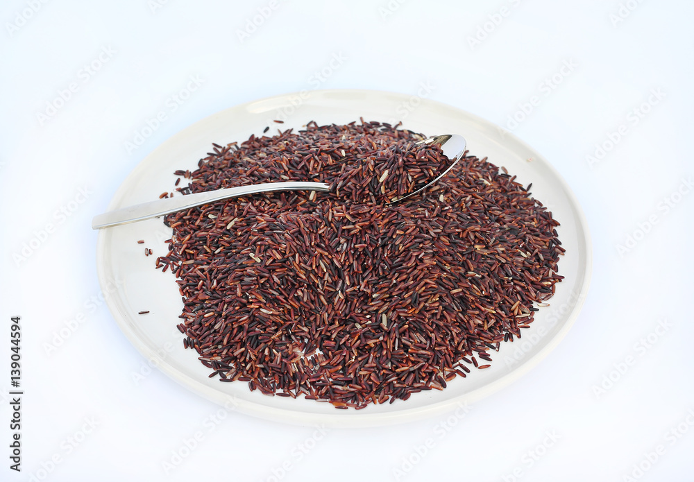 Jasmine red rice with spoon against white background. Jasmine red rice with spoon against white background.