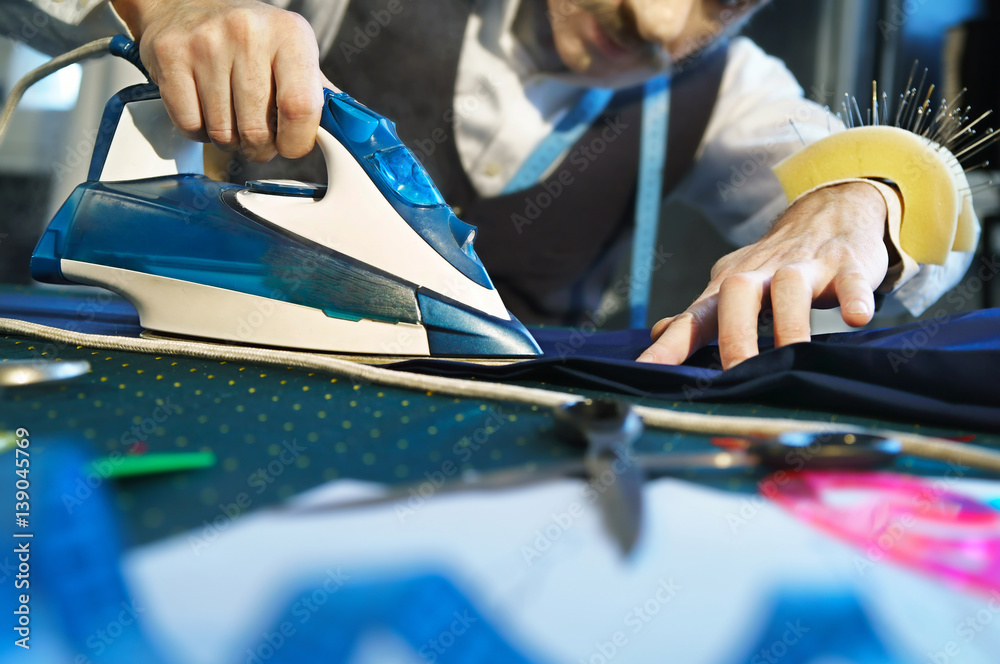 Tailor irons the pants