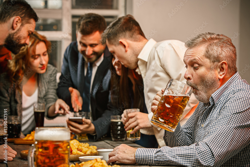 Group of friends enjoying evening drinks with beer Group of friends enjoying evening drinks with beer