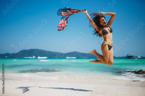 Jumping happy girl on the beach